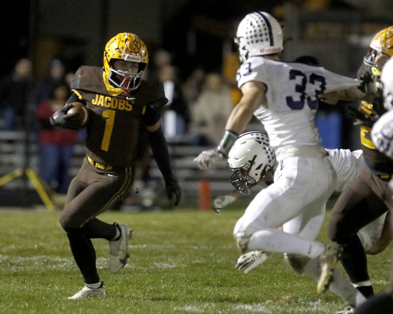 Jacobs' Justin Gonzalez runs the ball as Cary-Grove's Olive Antonelli tries to close in during a Fox Valley Conference football game on Friday, Oct. 24, 2025, at Jacobs High School in Algonquin.