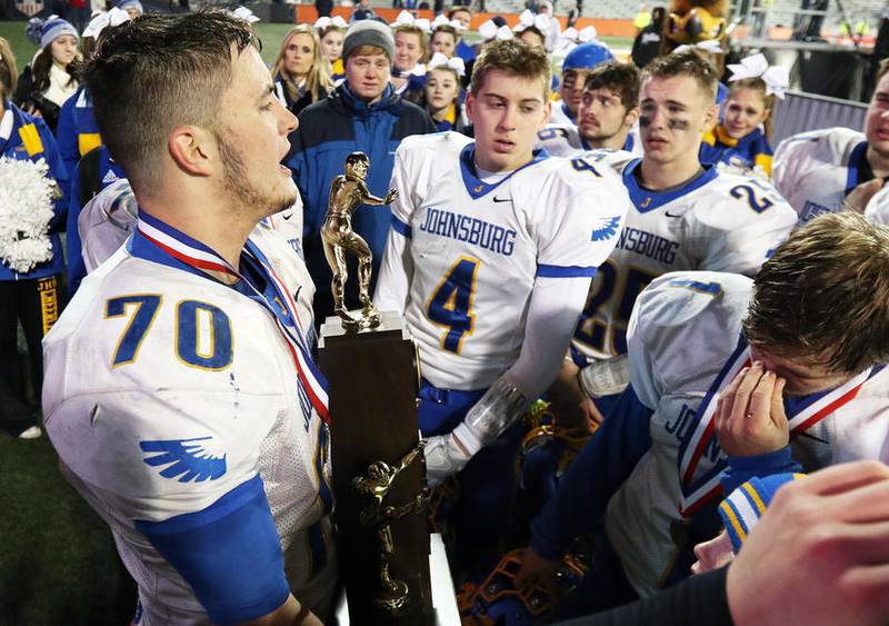 Holding the second-place state trophy, Johnsburg team captain Joe Moore addresses teammates after the Skyhawks' 38-14 loss to Rochester in the Class 4A state final Friday, Nov. 25, 2016, in Champaign.