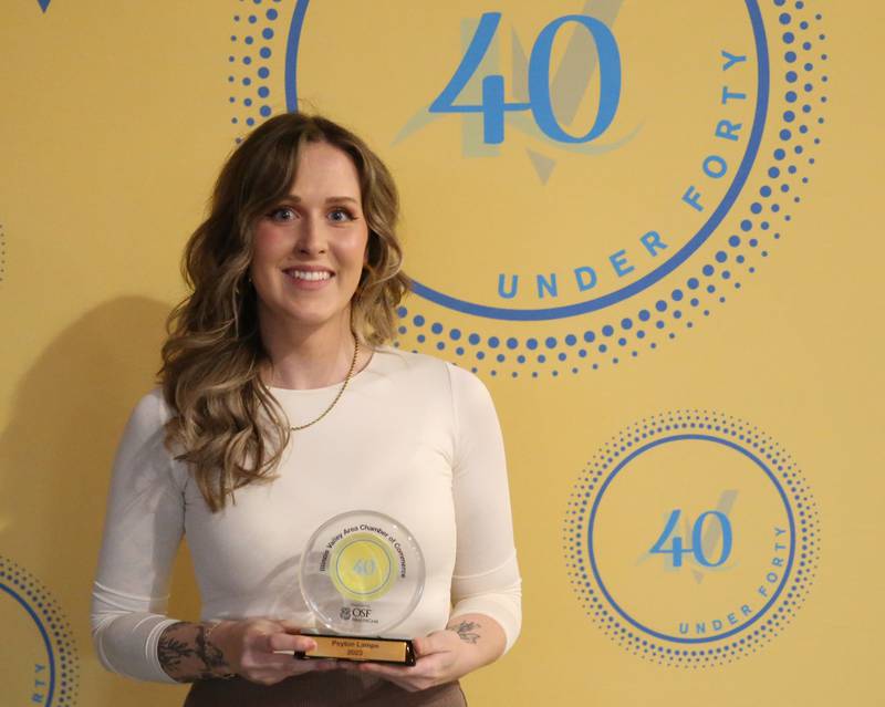 Peyton Lamps poses for a photo with her award during the 40 Under Forty awards banquet on Thursday, March 21, 2024 at Westclox in Peru.