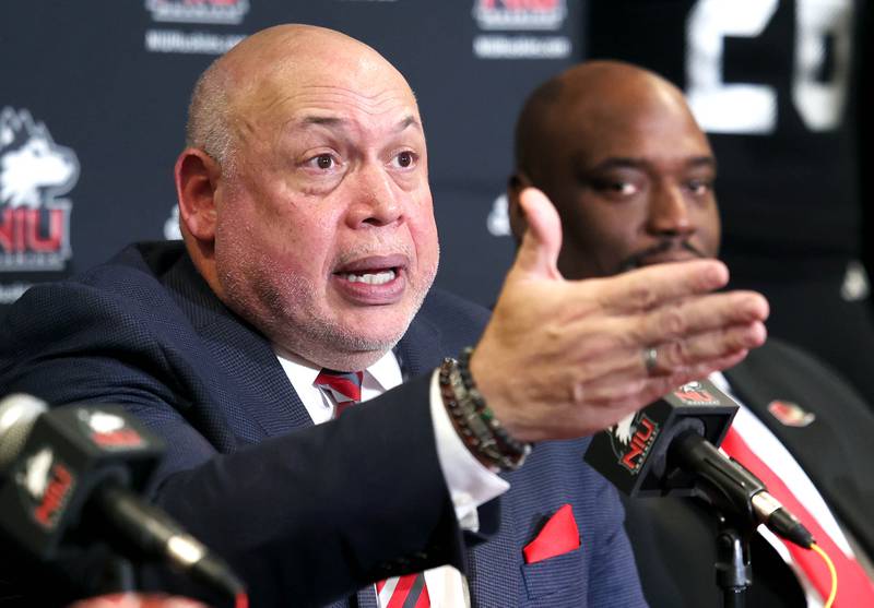 Northern Illinois University vice president and director of athletics and recreation Sean Frazier  (left) answers a question as head football coach Thomas Hammock looks on during a press conference Tuesday, Jan. 7, 2025, announcing that NIU football will be joining the Mountain West Conference starting with the 2026 season.