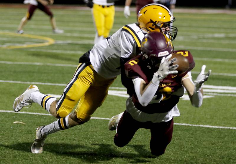 Richmond-Burton's Jace Nelson catches a pass in front of St. Laurence's Jimmy McDermott during an IHSA Class 4A first-round football game on Friday, Nov. 1, 2024, at Richmond-Burton High School in Richmond.