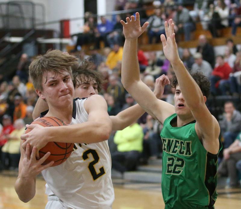 Putnam County's Andre Pyszka (left) grabs a rebound over Seneca's Dominic Traina (right) on Friday, Dec. 16, 2022 at Putnam County High School.