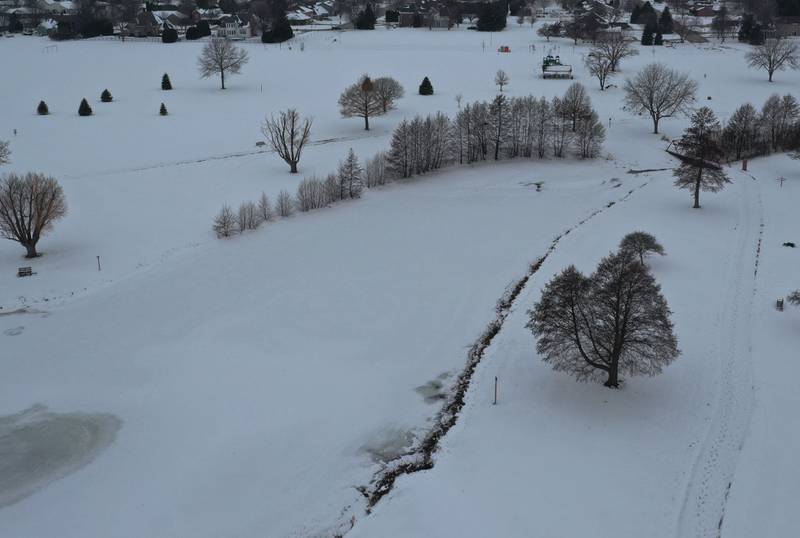 An aerial view of Baker Lake looking west on Tuesday, Dec. 9, 2025 in Peru. The concrete pathways have been poured but they will not be plowed this winter in order for the concrete to properly cure. Plowing the walkways to soon and applying salt could cause cracking and divots to the surface. Construction work began in early October and the park still remains closed to the public.