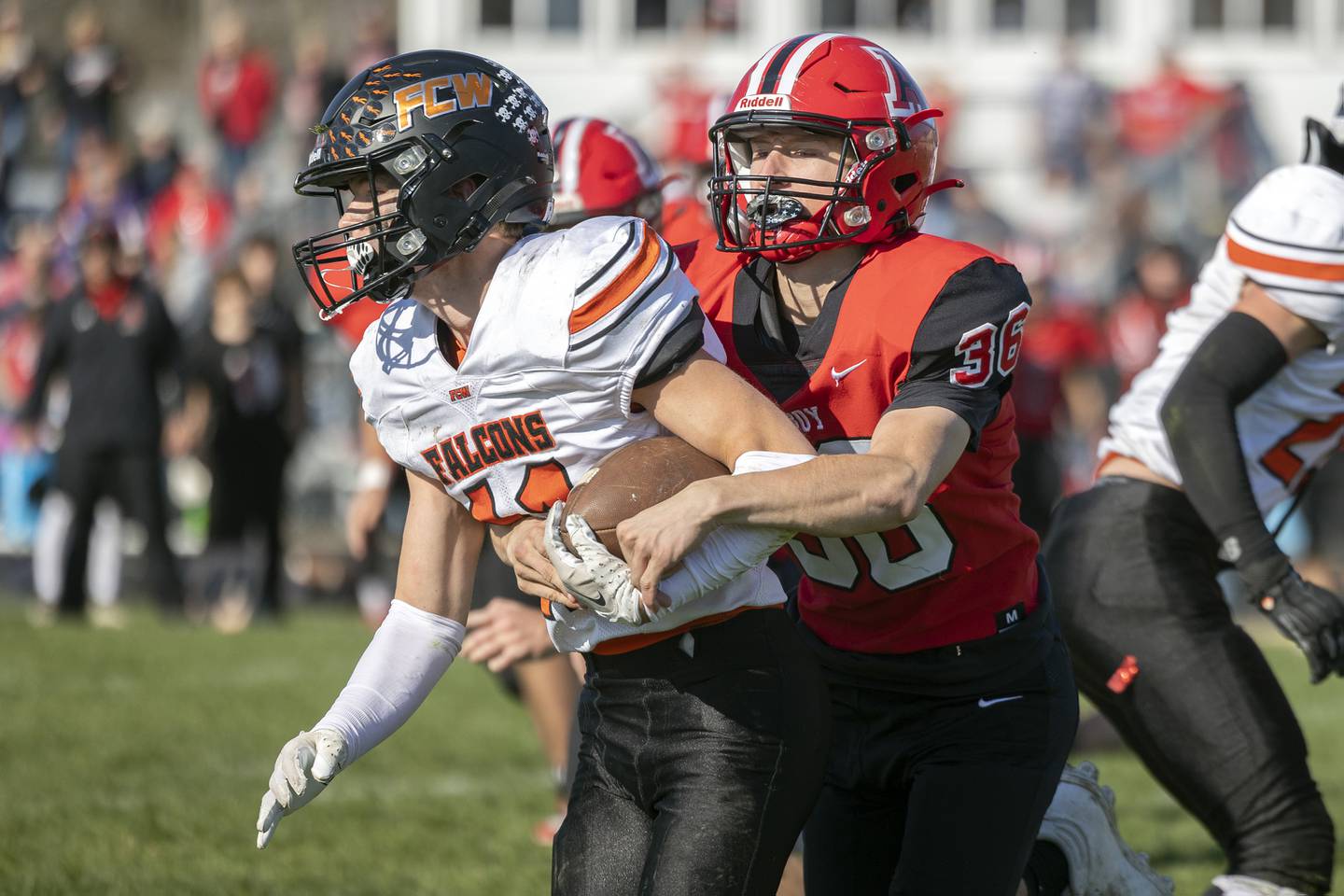 FCW’s Jonathan Moore is hauled down by Amboy’s Caleb Yanos Saturday, Nov. 4, 2023 in the 8-man semifinal game in Amboy.