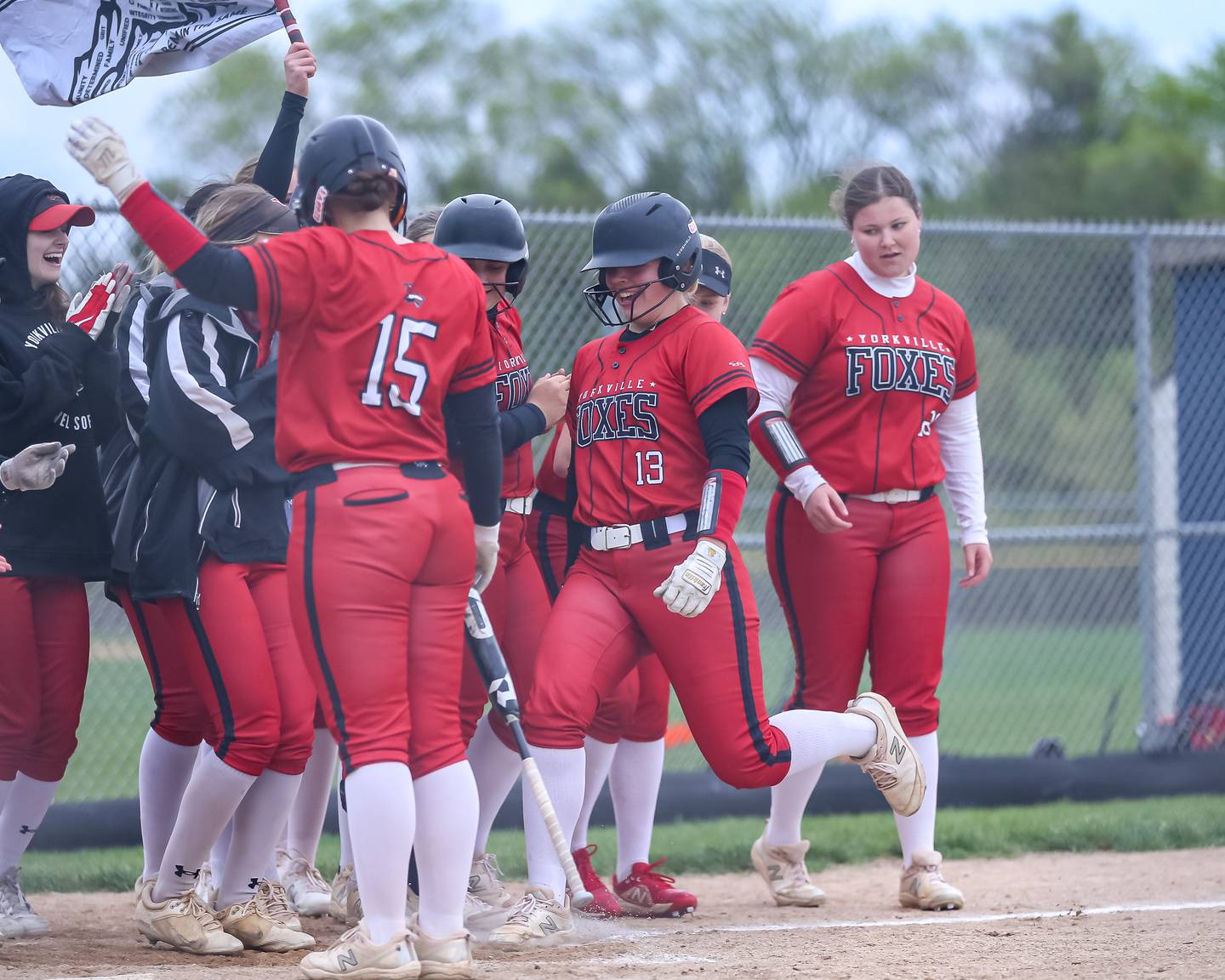 Yorkville's Ellie Fox (13) is greeted at the plate after hitting a homerun during softball game between Yorkville at Oswego East. April 17th, 2024.