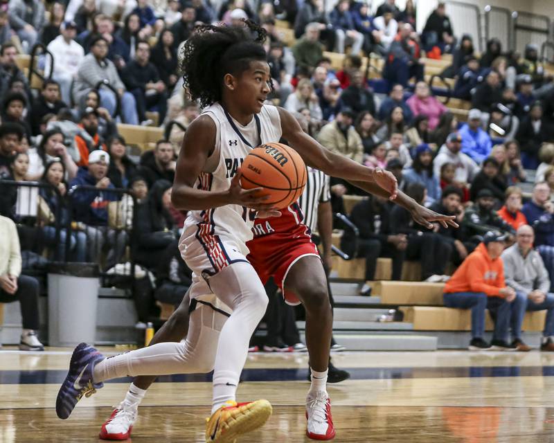 Oswego's MJ Johnson (10) drives baseline during their basketball game between West Aurora at Oswego Monday, Nov 24, 2025 in Oswego.