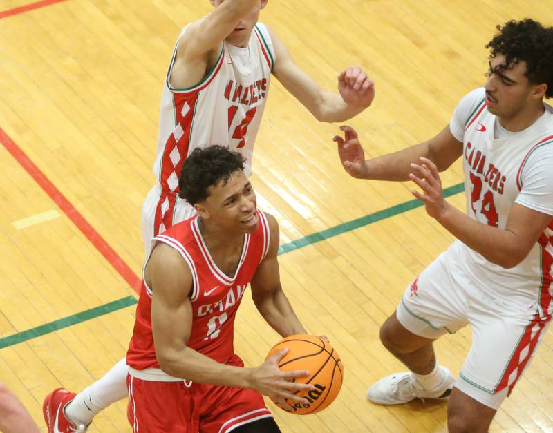 Ottawa's Hezekiah Joachim eyes the hoop after getting by L-P's Wyatt Kilday and Marion Persich during the Class 3A Regional title game on Wednesday, Feb. 25, 2026 in Sellett Gymnasium at L-P High School.