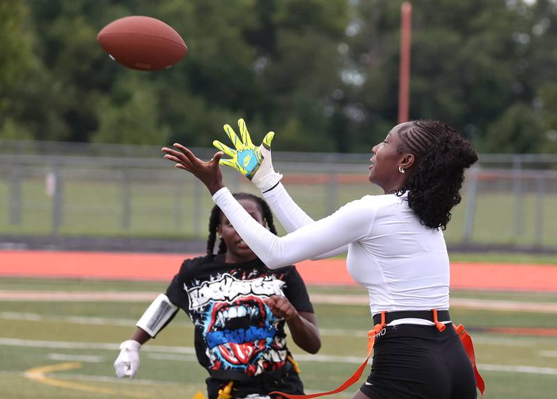 DeKalb’s Me’She Eubanks catches a pass as Kaylee Tenard provides the coverage Wednesday, Aug. 20, 2025, during the first practice of the DeKalb High School flag football team. The squad is preparing for their inaugural season.
