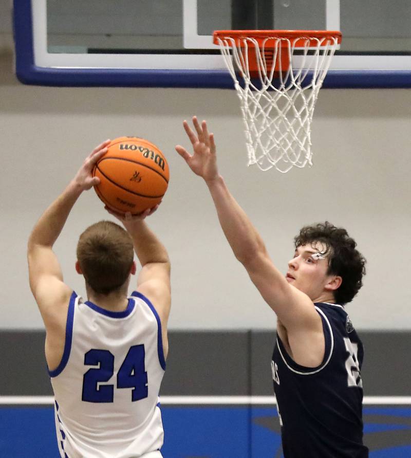 Cary-Grove's Adam Bauer (right) tries to block the shot of Burlington Central's Bennek Braden during a Fox Valley Conference boys basketball game on Friday, February. 6, 2026, at Burlington Central High School.