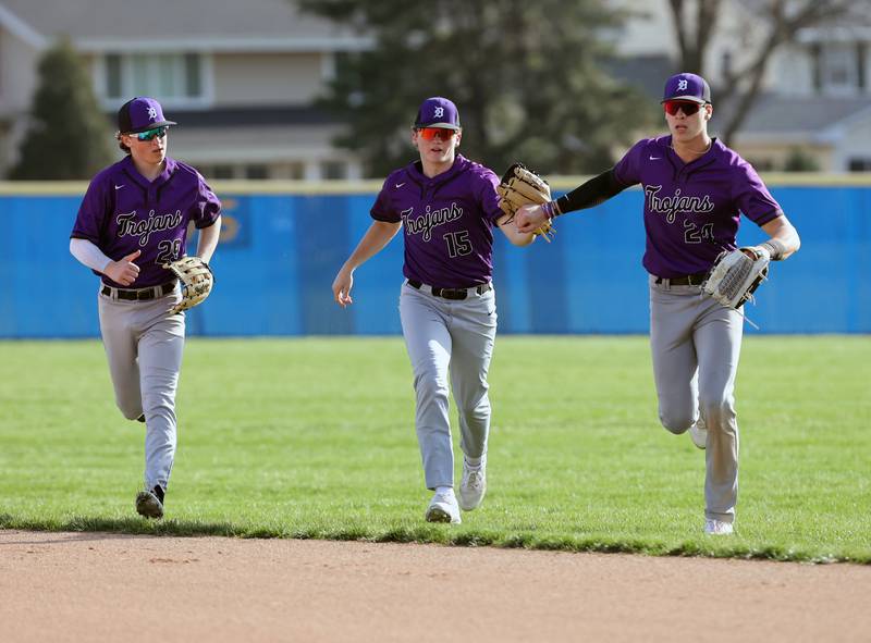 Downers Grove North's Tommy Finley (15) is congratulated by his teammates after a catch during the boys varsity baseball game between Lyons Township and Downers Grove North high schools in Western Springs on Tuesday, April 11, 2023.