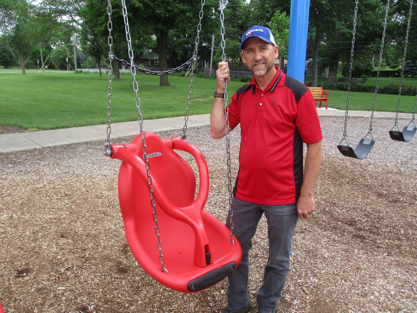 Yorkville Superintendent of Parks Scott Sleezer is proud of playground swings like this one designed for special needs children. He is shown here in Beecher Park. (Mark Foster -- mfoster@shawmedia.com)