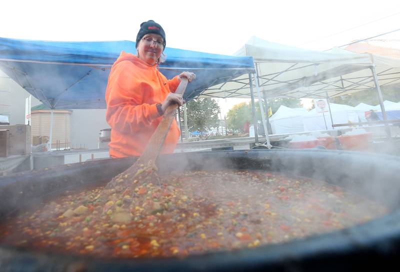 Melissa Herron of Peru, stirs a large pot of Burgoo during the 55th annual Burgoo Festival on Sunday, Oct. 12, 2025 in Utica.