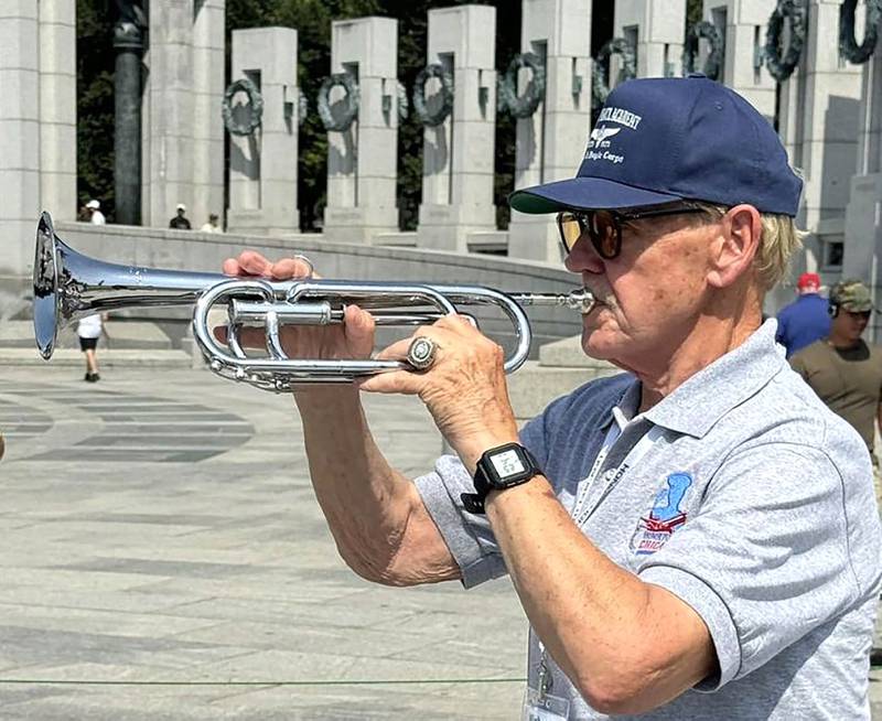 U.S. Air Force veteran Michael Embrey, of DeKalb, plays "Taps" in Washington D.C. on Aug. 28, 2024, during his time on a Chicago Honor Flight out of Chicago.