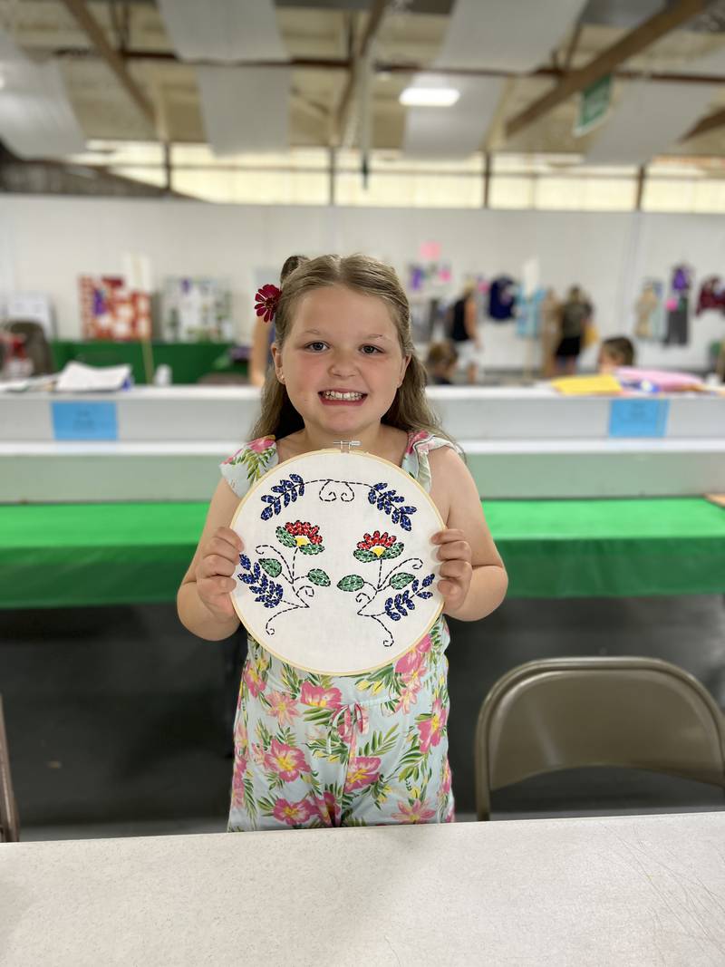 First-year 4-H member Adelaide Baldwin of Yorkville shows her heritage arts project during judging at the Kendall County Fair.