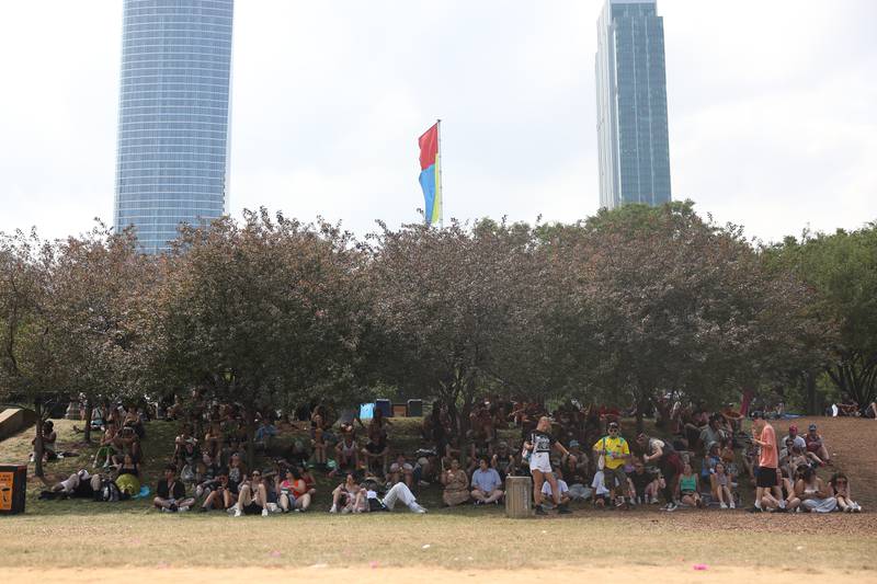 A group of festival goers find shade under the trees at Lollapalooza on Saturday, Aug. 3, 2024 in Chicago.