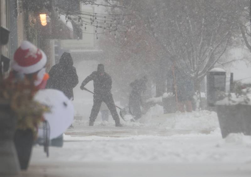 People shovel snow as heavy flakes fall on Saturday, Nov. 29, 2025 downtown La Salle.