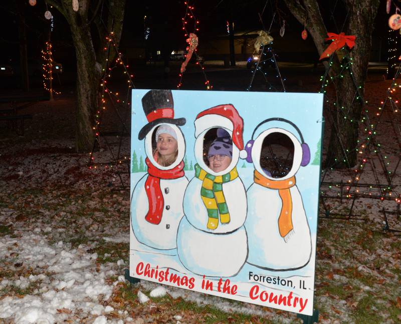 Emmerson Thiel and Emily Roop, of Forreston, pose for a photo at Memorial Park during Forreston's Christmas in the Country on Friday, Dec. 1, 2023. The seven year olds were waiting for Santa to arrive.