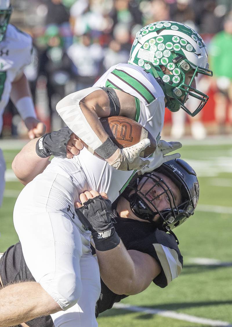 Lena-Winslow’s Gannon Dunker takes down Brown County's Beau Little Friday, Nov. 28, 2025, in the Class 1A football finals at Hancock Stadium at ISU.