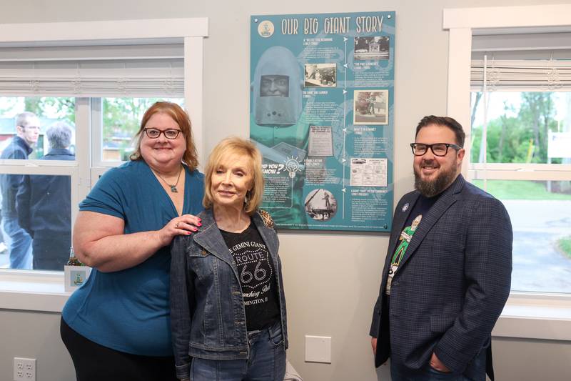 Greg Peerbolte, chief executive officer of the Joliet Area Historical Museum, right, stands with Sharon Gatties, center, of Wilmington, and her daughter Jori Taylor inside The Landing Pad Souvenir Shop near a display sharing the story of the Gemini Giant. 
Gatties' parents, John and Bernice Korelc, were the original owners of the Giant after purchasing him in 1965 to attract tourists to the Dan-Delight restaurant, which they purchased from original owners Doris and Darrell Lantz, who opened along Route 66 in 1957. The Dan-Delight would be rebranded as The Launching Pad Drive-In in 1960.
The Korelcs operated the drive-in until 1986 when they sold the operation to their daughter, Gatties, and her husband Jerry, which they operated until 2007.