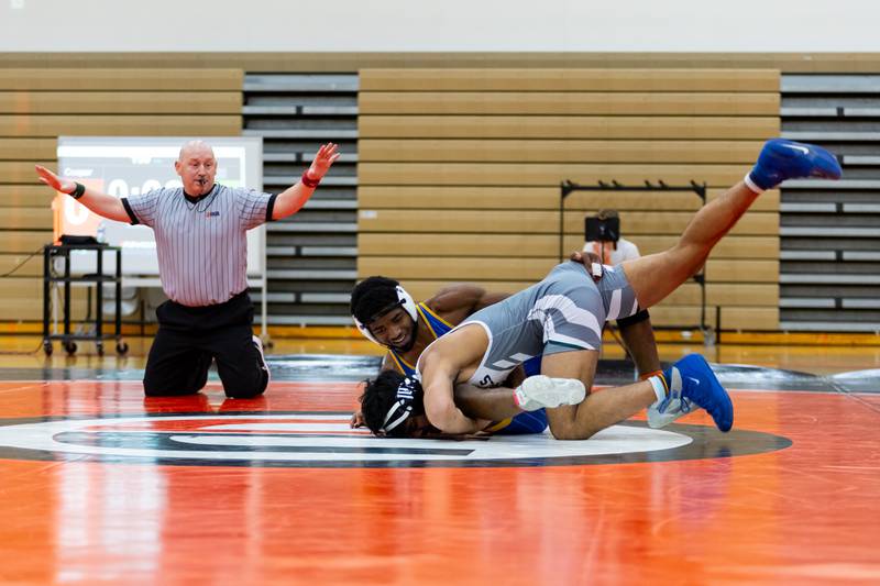 Joliet Central's Tremaine Cooper goes up against Muhammad Ali Hasib of Plainfield East in the 150-pound match at Plainfield East on Dec. 12, 2024.