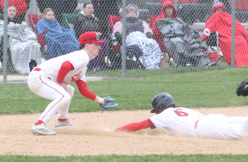 Hall's Hunter Edgcomb dives into third base as Ottawa's Jacob Rosetto catches the late throw on Tuesday, April 1, 2025 at Ottawa High School.