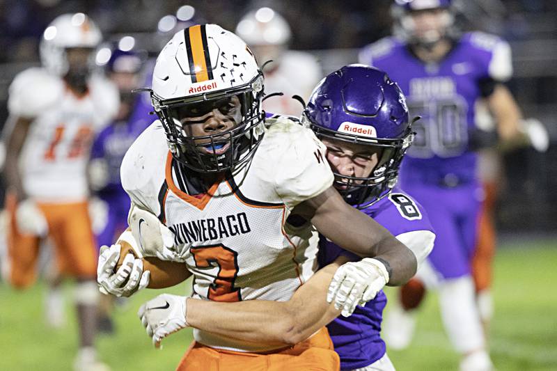 Winnebago’s Supreme Muhammad is hauled down by Dixon’s Tyson Dambman Friday, Sept. 29, 2023 in Dixon.