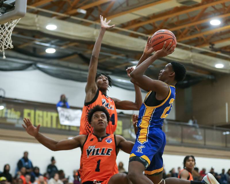 Joliet Central's Danny Thompson (23) puts up a shot over Romeoville's Adam Walker (34) in the WJOL Tournament Championship game. Nov 25, 2023.