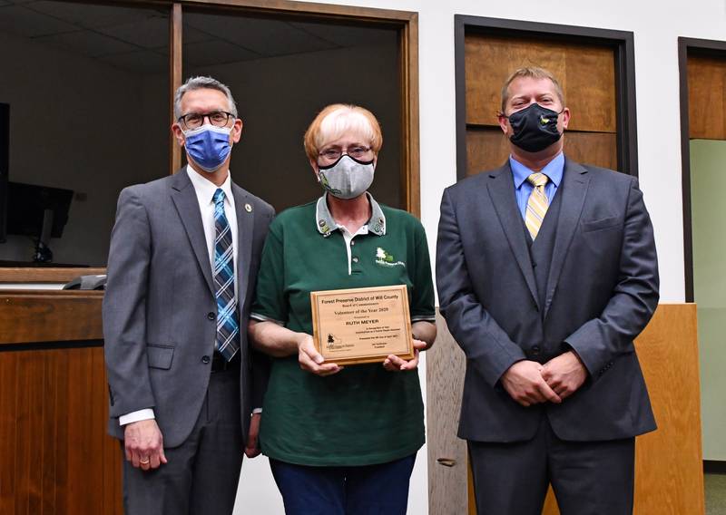 Ruth Meyer of Joliet, center, picks up her Volunteer of the Year Award on April 8 from the Forest Preserve District of Will County. Presenting the award to Meyer were Chief Operating Officer Ralph Schultz, left, and Board of Commissioners President Joe VanDuyne, right.