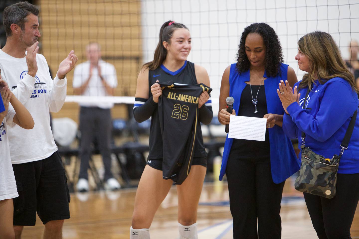 St. Charles North's Head Coach Lindsey Hawkins presents Hailey Burgdorf with her Under Armor All American jersey on Monday, Oct. 6, 2025 in St. Charles.