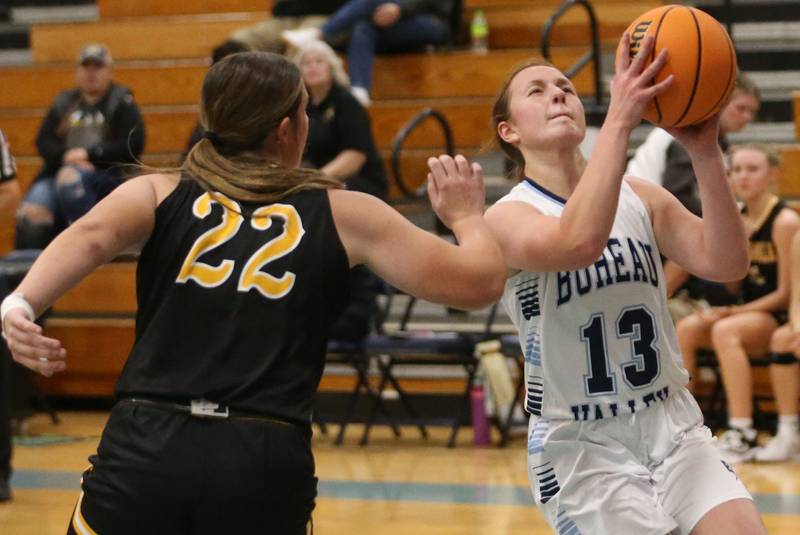 Bureau Valley's Libby Endress cuts in the lane to score on a layup over Riverdale's Katie Cox during the Thanksgiving Tournament on Wednesday, Nov. 20, 2024 at Bureau Valley High School.