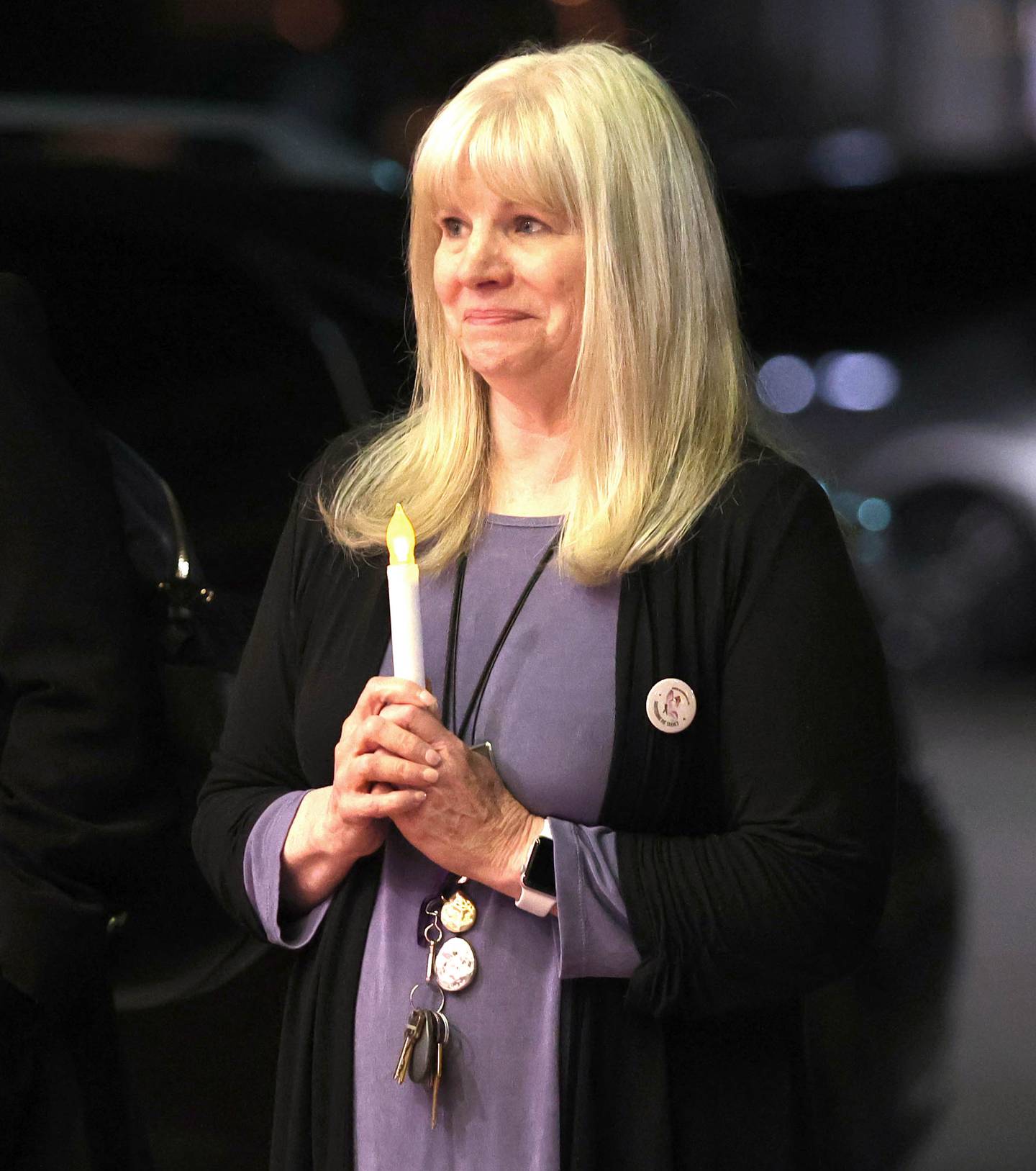 Mary Ellen Schaid, Safe Passage executive director, holds a candle Monday, Oct. 3, 2022, at the Egyptian Theatre during the Safe Passage domestic violence vigil.