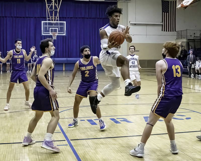 Newman's Marcus Williams looks to pass the ball between Mendota defenders Ted Landgraf (left), Isaac Guzman (2) and Ryne Strouss (13) during their Three Rivers East game Friday night in Sterling.