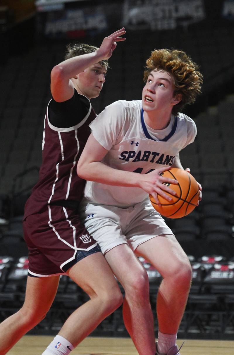 St. Francis’ Ben Whorlow makes a move toward the basket against Wheaton Academy’s Hayden Schroeder during a boys basketball game played at NOW Arena on Thursday, Jan. 16, 2025 in Hoffman Estates.
