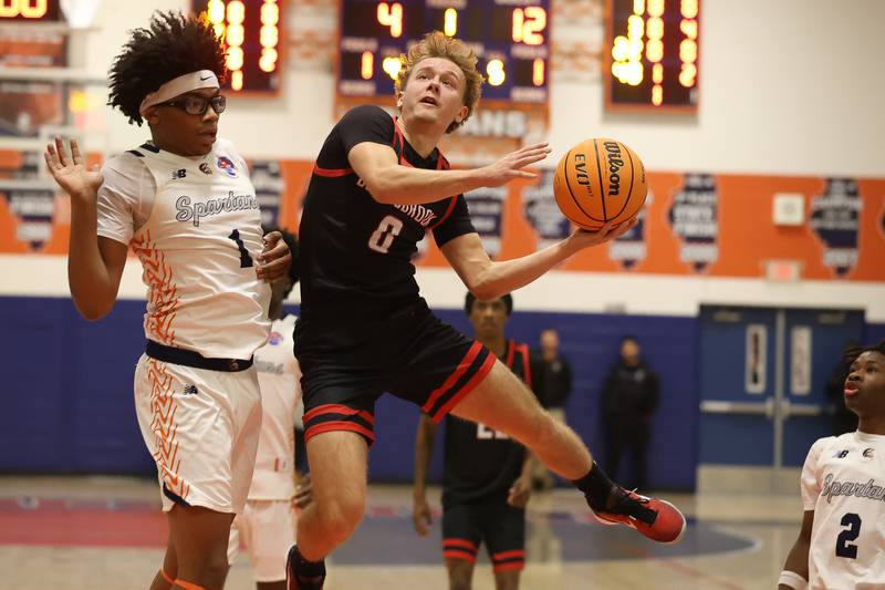 Bolingbrook's Trey Brost finesses a shot against Romeoville on Tuesday, Dec. 2, 2025 in Romeoville.