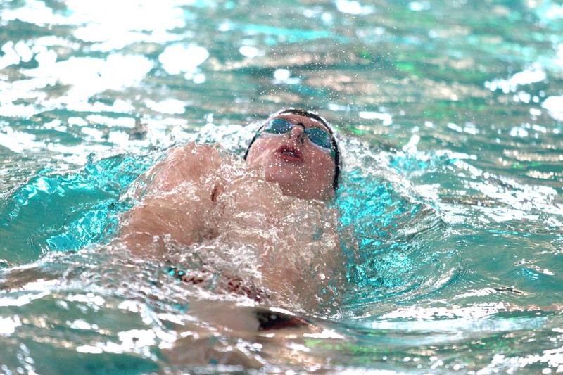 Cary-Grove’s Drew Watson cruises through the 100-yard backstroke at the Fox Valley Conference Boys Swimming Invite at Woodstock North on Saturday.