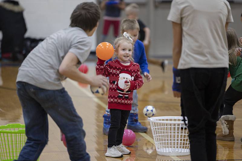 Remi Nailor, 3, looks to fire off a ball Saturday, Nov. 19, 2022 during Rock Falls Chamber’s Grinch dodgeball. The event was part of the chamber’s Hometown Holidays.