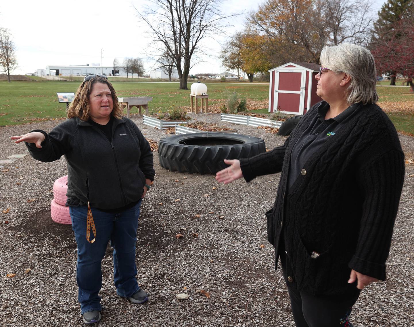 Stephanie Davies, (left) children's garden coordinator for the DeKalb County Regional Office of Education, and Amanda Christensen, regional superintendent of schools for DeKalb County, talk Thursday, Nov. 13, 2025, about the toddler garden at Lions Community Park in Waterman.