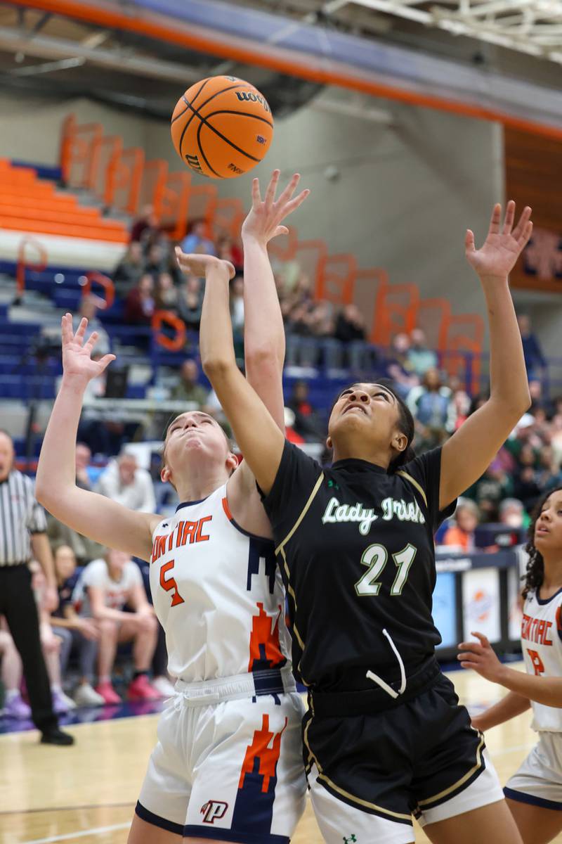 Bishop McNamara’s Keneyce Davis, right, reaches for a rebound during the Fightin’ Irish’s 46-32 loss to Pontiac in the IHSA Class 2A Pontiac Sectional semifinal on Tuesday, Feb. 24, 2026, at Pontiac Township High School.