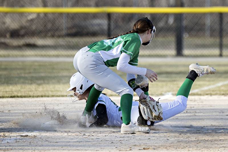 Rock Falls’ Maddison Morgan slides in safely at third base against Geneseo Wednesday March 29, 2023.