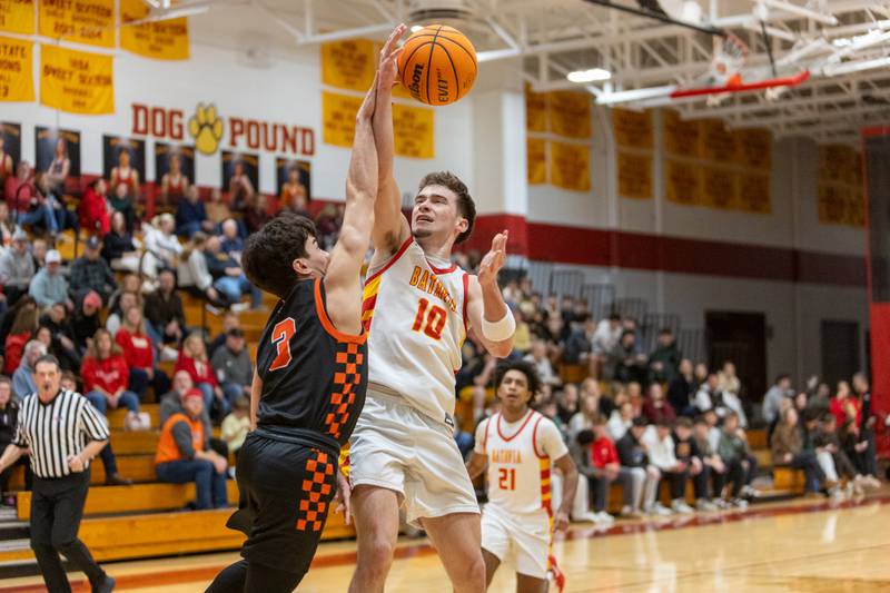 Batavia's Joe Reid goes in for the layup over St. Charles East's Reese Dumpit on Friday, Jan.9,2026 in Batavia.