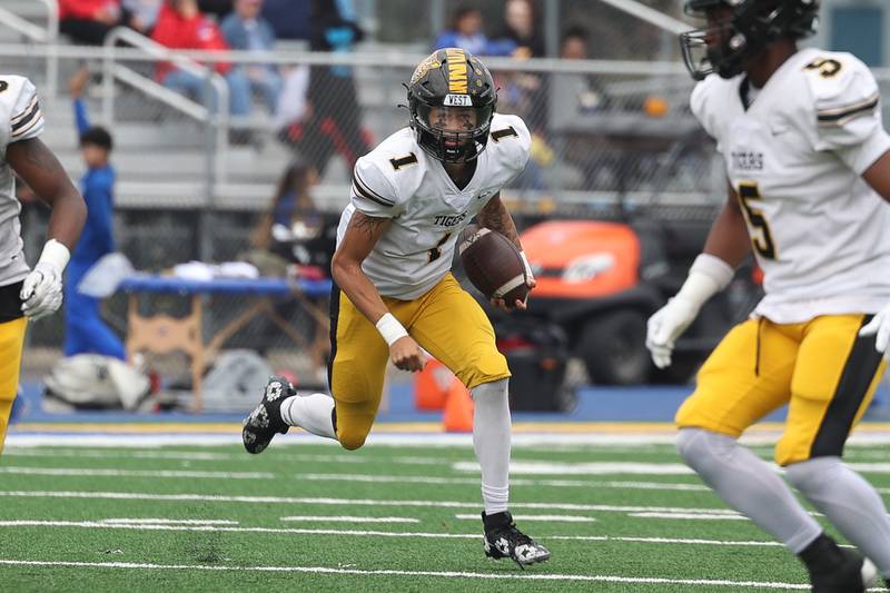 Joliet West’s Antonio Brooks scrambles to the outside against Joliet Central on Saturday, Sept. 28, 2024 in Joliet.