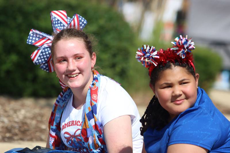 Ariah Boyd, 10, right, and Annabella Kirksey, 10, wait for the Huntley Independence Day Parade along Main Street in Huntley on Friday, July 4, 2025. Both are from Huntley.