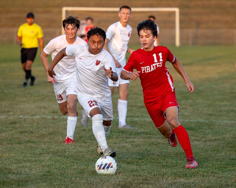 (from left) Shuarlin Cucul Cal (23) of L-P dribbles ball forward as Alexio Fernandez (11) of Ottawa follows on Wednesday, Sept. 17, 2025 at Ottawa High School in Ottawa.