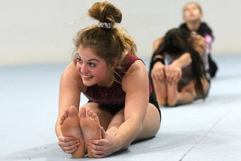 Prairie Ridge co-op's Gracie Willis stretches during gymnastics practice at Crystal Lake Gymnastics Training Center on Monday in Crystal Lake.