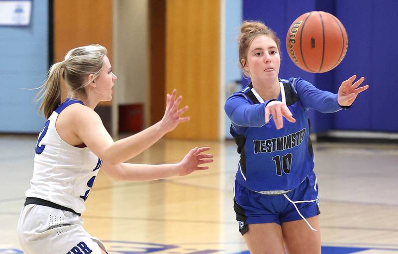 Westminster Christian's Meadow Oesterle passesnthe ball away from Hinckley-Big Rock's Anna Herrmann during their regional semifinal game Monday, Feb. 13, 2023, at Hinckley-Big Rock High School.