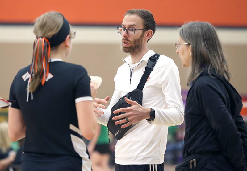 DeKalb junior Carly Kammes talks to her coaches during a break in her match against Dana Bogda, a senior from Lincoln-Way West Friday, May 10, 2024, during the IHSA State Badminton Finals at DeKalb High School. Kammes was able to advance after defeating Bogda.