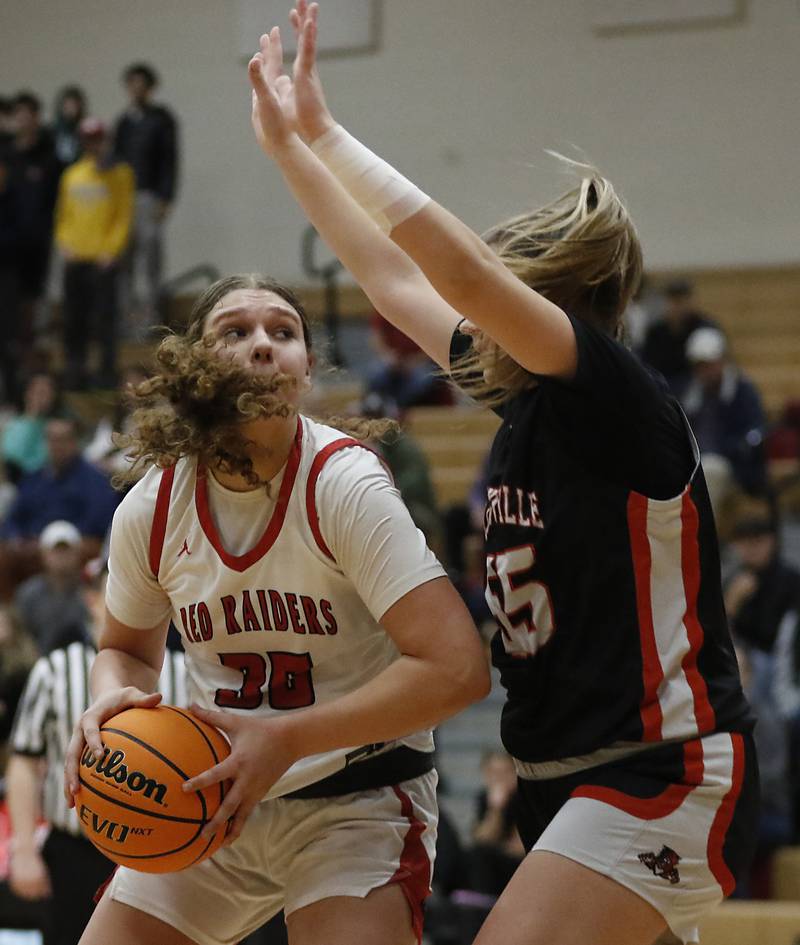 Huntley's Paula Strzelecki drives to the basket against Libertyville's Madison Sears during the IHSA Class 4A Huntley Sectional Championship girls basketball game on Thursday, Feb. 27, 2025, at Huntley High School.