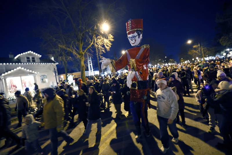 A Giant nutcracker makes its way down Third Street during Candy Cane Parade Friday, Dec. 6, 2024 in Geneva.