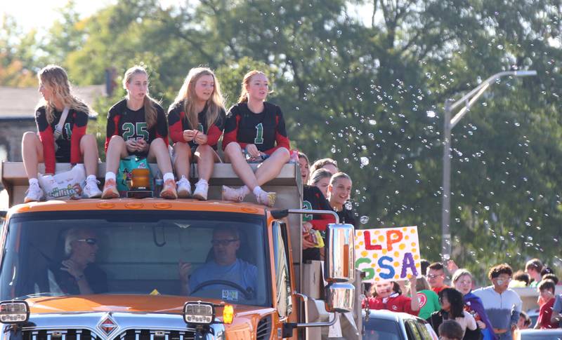 Members of the L-P Volleyball team and the L-P Gay-Straight Alliance club ride in the Homecoming parade on Thursday, Oct. 5, 2023 downtown Peru.