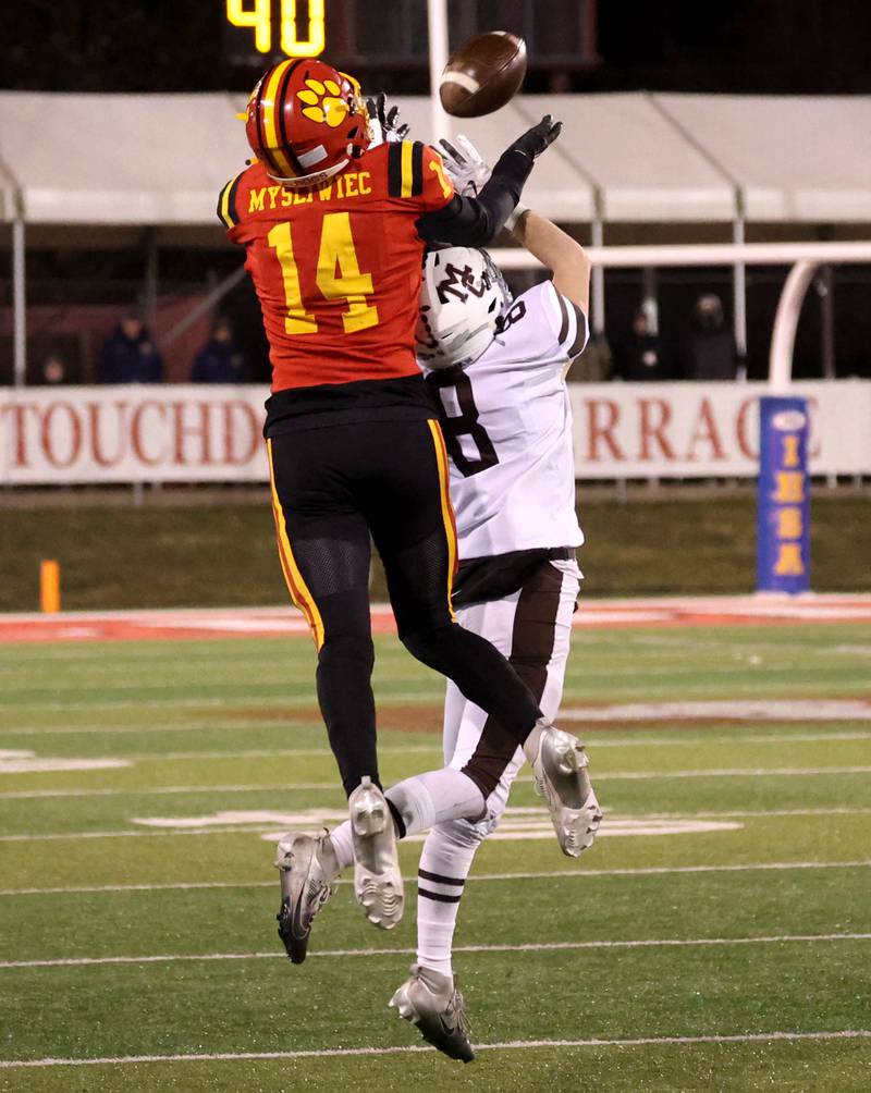 Batavia's Jake Mysliwiec tries to catch a pass over Mt. Carmel's Jackson Barrins during their Class 8A state championship game Saturday, Nov. 30, 2024, in Hancock Stadium at Illinois State University in Normal.